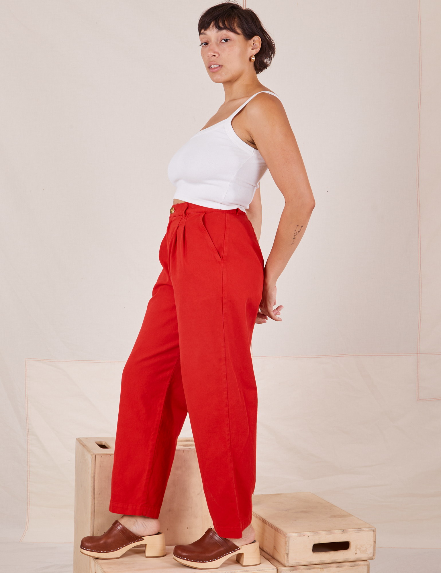 Side view of Heavyweight Trousers in Mustang Red and Cropped Cami in vintage tee off-white worn by Tiara