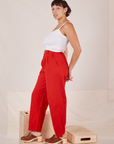 Side view of Heavyweight Trousers in Mustang Red and Cropped Cami in vintage tee off-white worn by Tiara