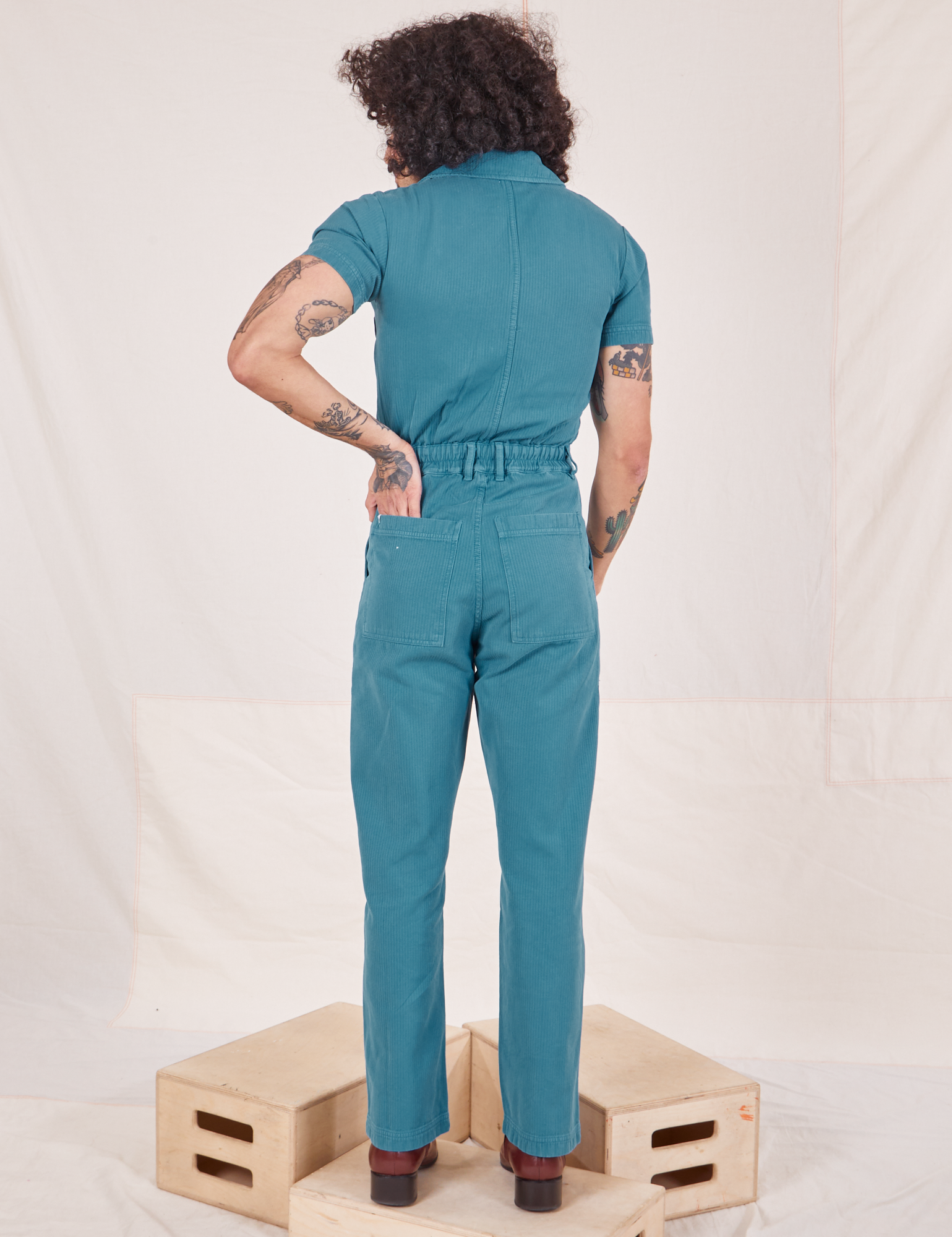 Back view of Heritage Short Sleeve Jumpsuit in Marine Blue worn by Jesse