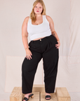 Juliet is 5’7” and wearing 0XL Heritage Trousers in Basic Black paired with a Cropped Tank in vintage tee off-white