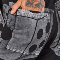 Back pocket close up of Icon Work Pants in Dice. Jesse has their hand in the pocket.
