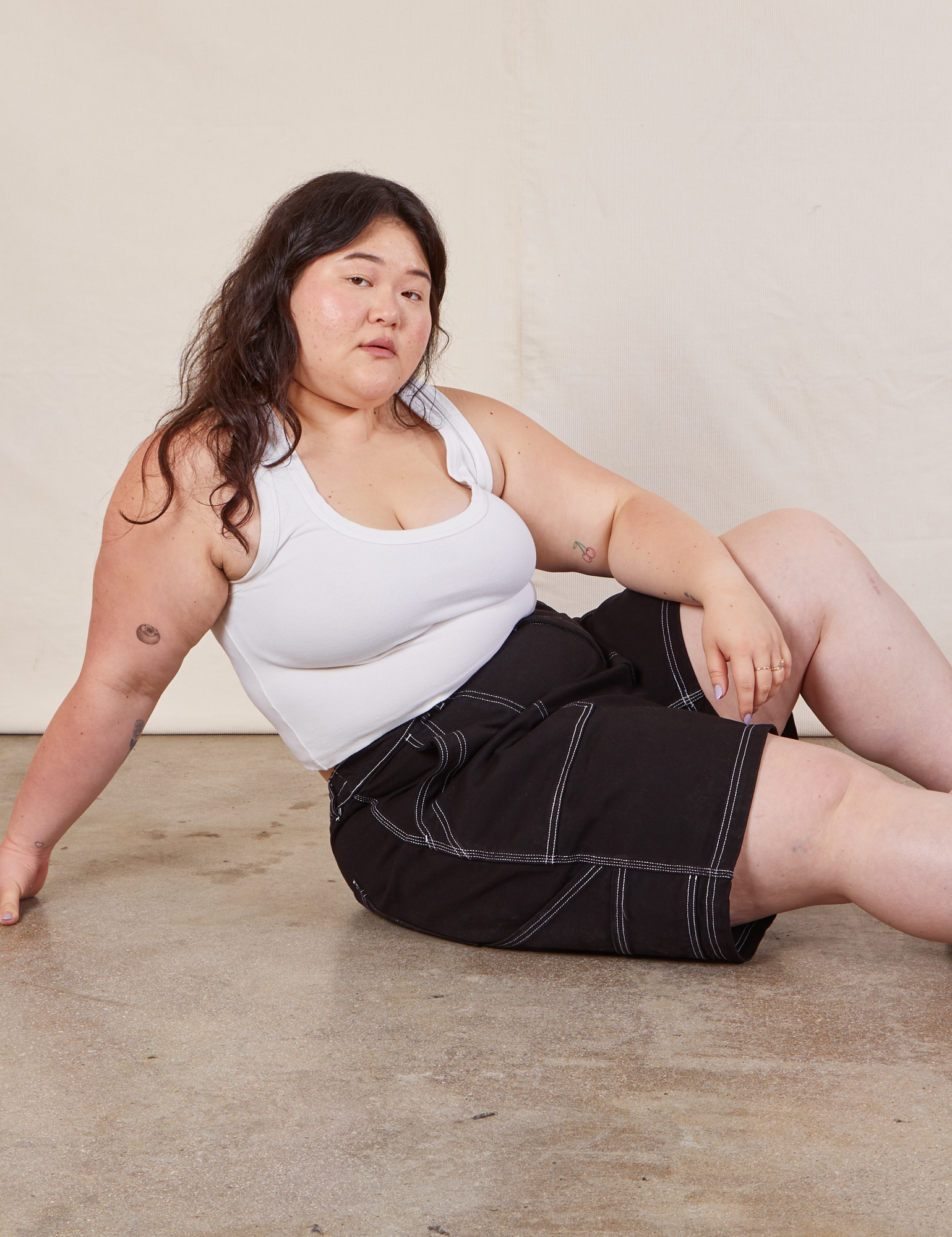 Ashley is wearing Carpenter Shorts in Basic Black and Cropped Tank in vintage tee off-white