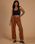Kandia is 5'3" and wearing XS Black Stripe Work Pants in Construction Orange