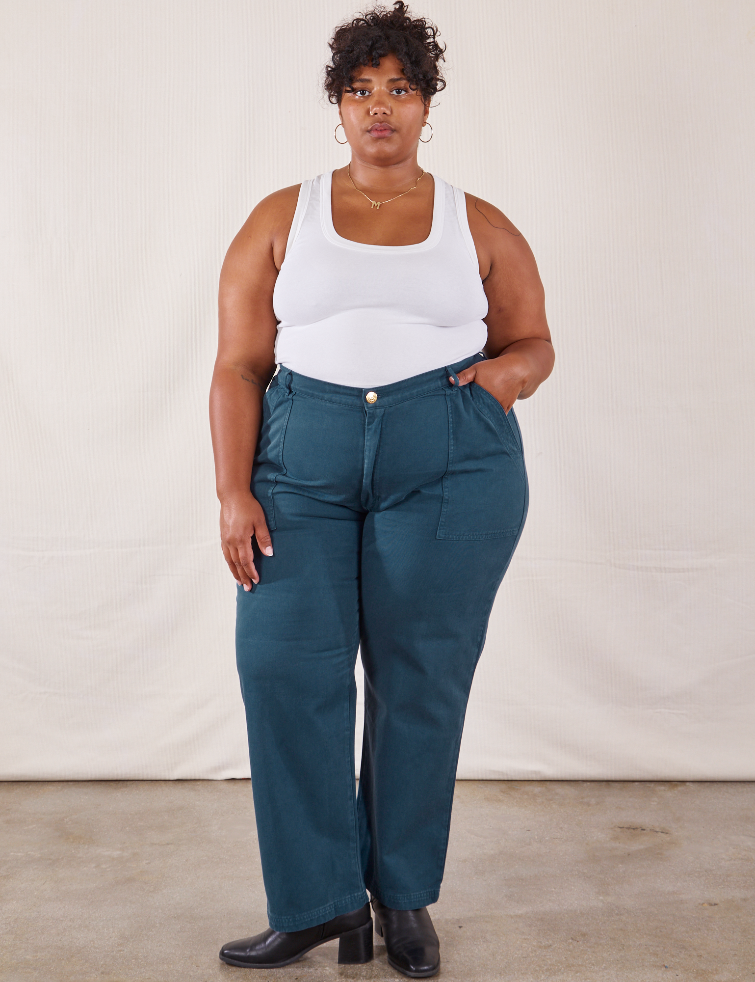 Morgan is 5'5" and wearing 2XL Work Pants in Lagoon paired with vintage tee off-white Tank Top