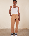 Jerrod is 6'3" S Long Work Pants in tan and wearing paired with Tank Top in vintage tee off-white