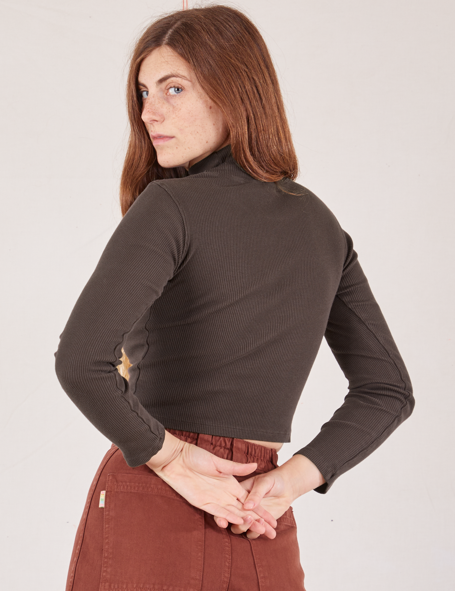 Angled back view of Essential Turtleneck in Espresso Brown on Scarlett