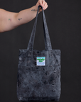 Everyday Tote in Black Magic Waters held by model