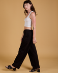 Baggy Mid-Rise Trousers in Basic Black side view on Alex