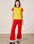 Alex is wearing Mismatched Tee in Yellow & Red and mustang red Western Pants