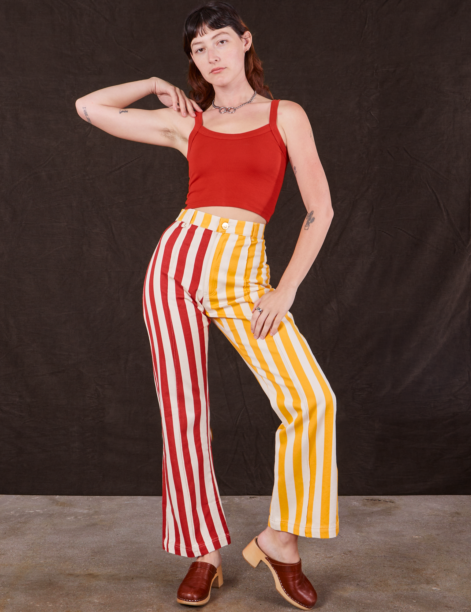 Alex is 5&#39;8&quot; and wearing XS Western Pants in Ketchup/Mustard Stripes paired with mustang red Cami