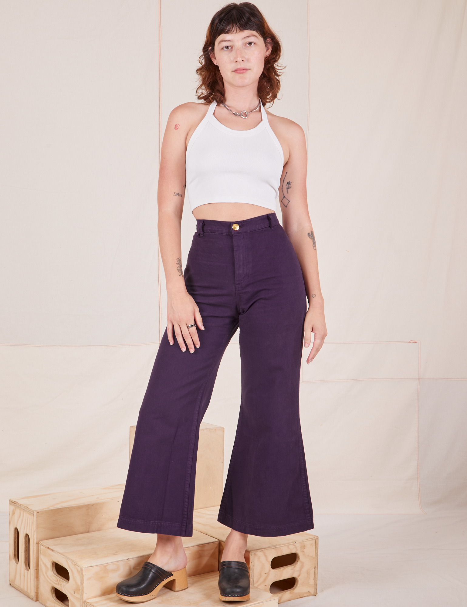 Alex is 5&#39;8&quot; and wearing XXS Bell Bottoms in Nebula Purple paired with Halter Top in vintage tee off-white