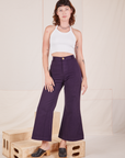 Alex is 5'8" and wearing XXS Bell Bottoms in Nebula Purple paired with Halter Top in vintage tee off-white