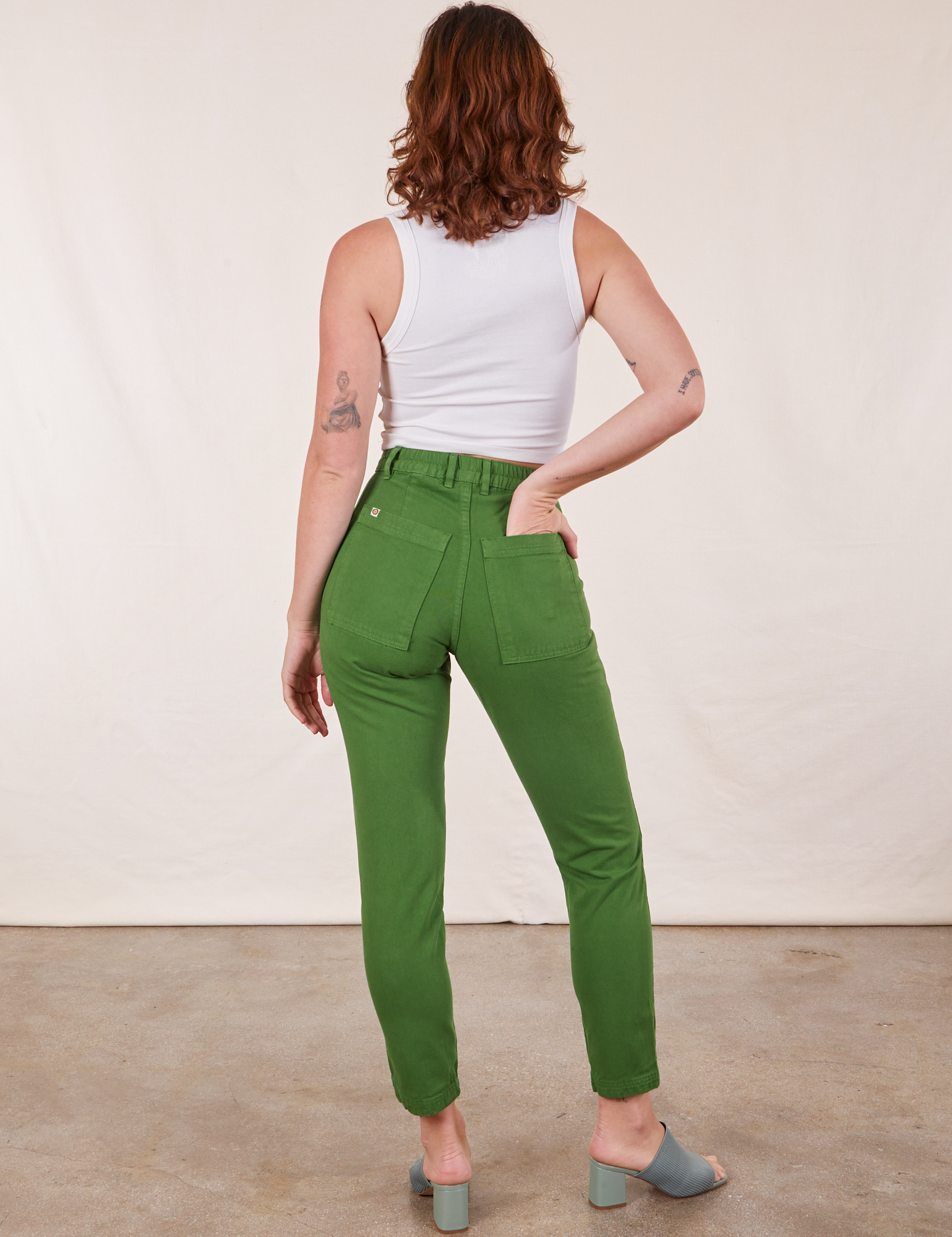 Back view of Pencil Pants in Lawn Green and vintage off-white Cropped Tank Top on Alex