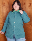 Ashley is wearing a buttoned up Quilted Overcoat in Marine Blue