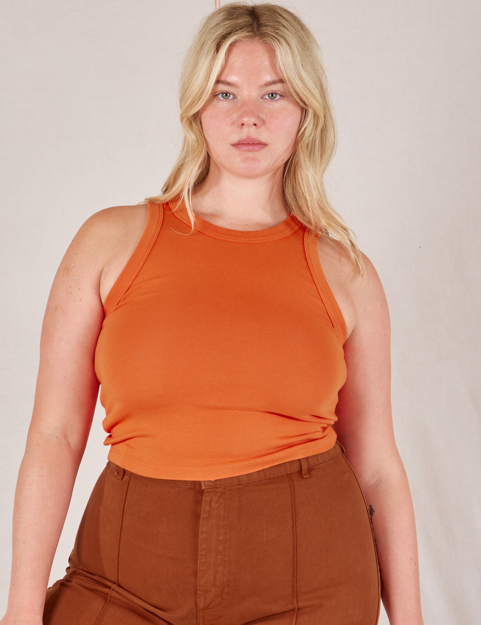 Lish is 5’8” and wearing L Racerback Tank in Sunset Orange