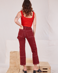Back view of Railroad Carpenter Jeans in Mustang Red and mustang red Square Neck Tank on Alex
