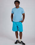 Isaac is 5’10” and wearing M Longline Work Shorts in Hawaiian Blue paired with baby blue Organic Vintage Tee