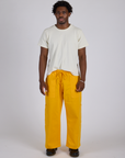 Isaac is 5’10” and wearing M Drop Pocket Cargo Pants in Sunshine Yellow paired with Organic Vintage Tee in Vintage Tee White