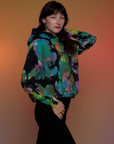 Angled front view of Oversized Hoodie in Rainbow Magic Waters on Alex