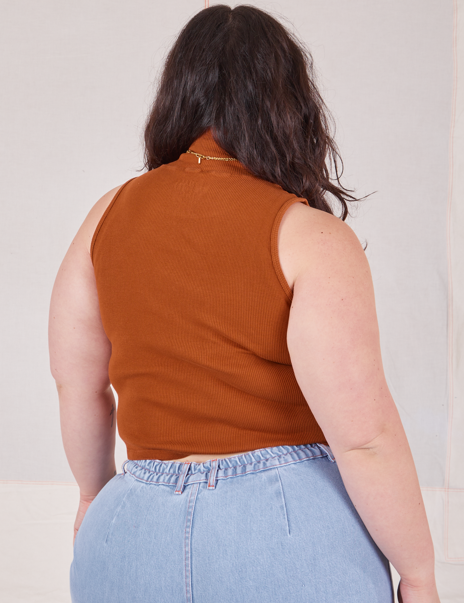 Back view of Sleeveless Essential Turtleneck in Burnt Terracotta on Ashley