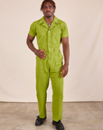 Issac is 5'10" and wearing M Short Sleeve Jumpsuit in Gross Green