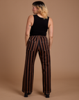 Back view of Black Stripe Work Pants in Fudgesicle Brown and black Cropped Tank on Tiara