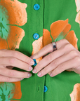 Paintstamped Pantry Button-Up in Kelly Green front close up on Alex. Contrast blue buttons