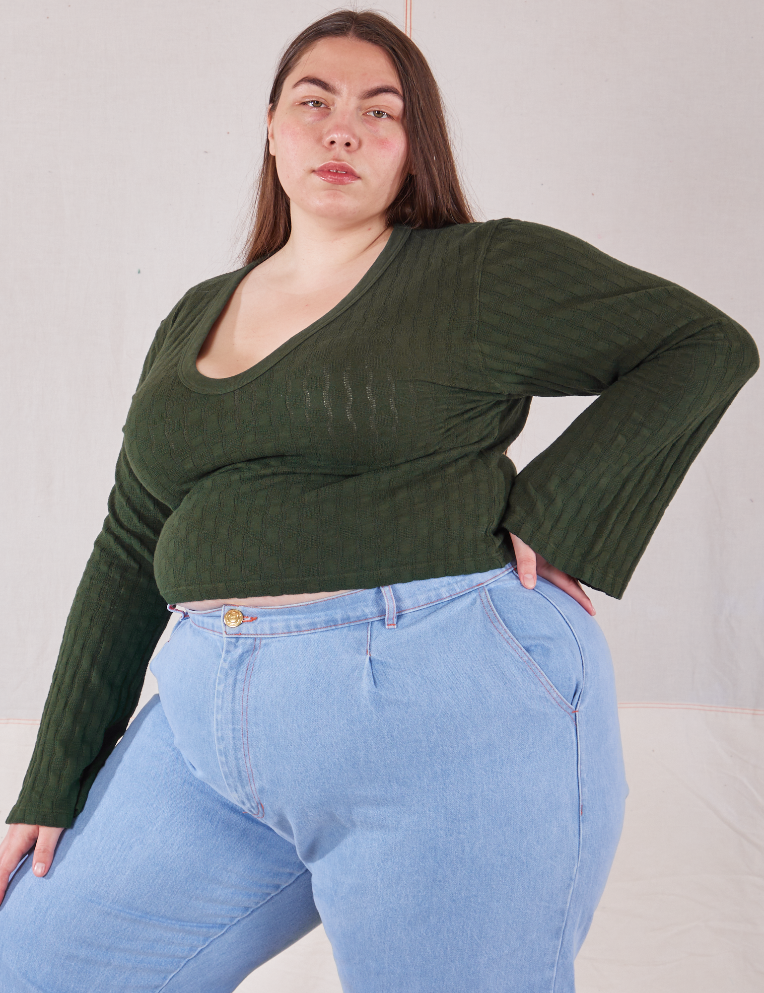 Angled view of Bell Sleeve Top in Swamp Green on Marielena