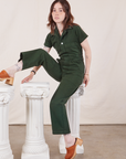 Hana is wearing Petite Short Sleeve Jumpsuit in Swamp Green