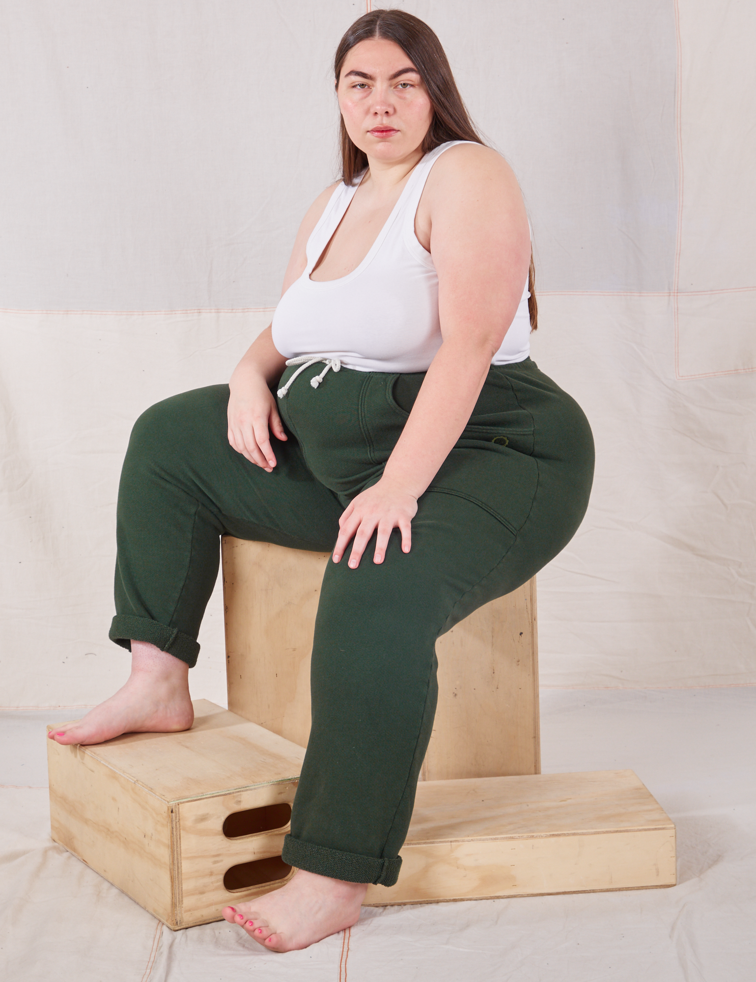 Marielena is wearing Rolled Cuff Sweat Pants in Swamp Green and vintage off-white Cropped Tank Top