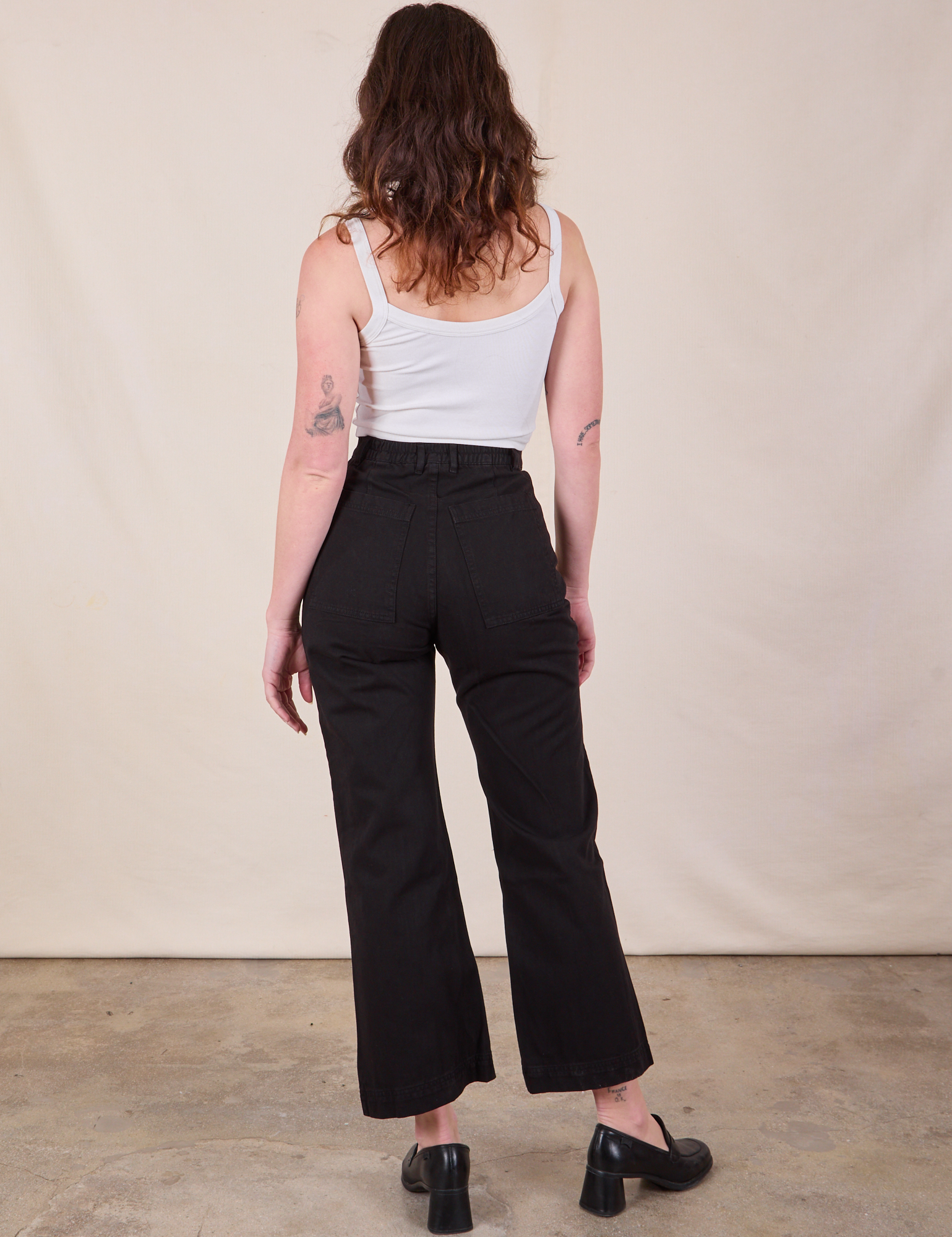 Back view of Western Pants in Basic Black and Cropped Cami in vintage tee off-white on Alex