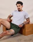 Jesse is wearing Classic Work Shorts in Swamp Green and Jr. Varsity Tee in Stone White