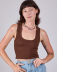 Alex is 5'8" and wearing P Cropped Tank Top in Fudgesicle Brown