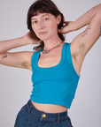 Alex is 5'8" and wearing P Cropped Tank Top in Hawaiian Blue