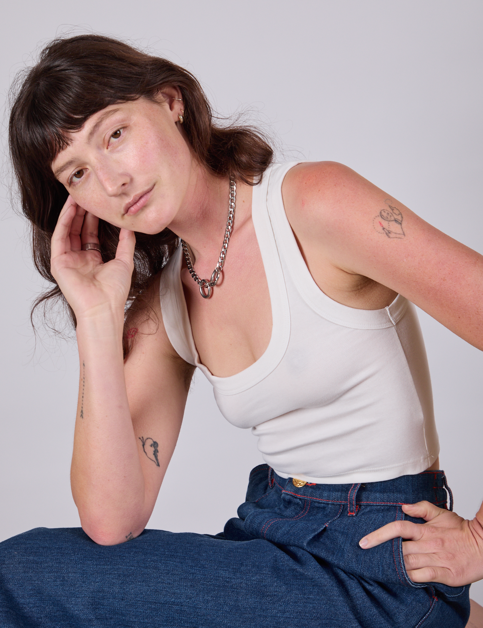 Alex is wearing Cropped Tank Top in Vintage Tee White