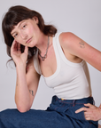 Alex is wearing Cropped Tank Top in Vintage Tee White