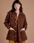 Alex is 5'8" and wearing XXS Ripstop Field Coat in Fudgesicle Brown
