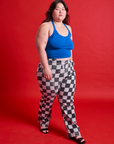 Ashley is 5'7" and wearing 1XL Checkerboard Work Pants in Black/White paired with a royal blue Halter Top