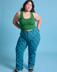 Ashley is 5'7" and wearing 1XL Checkerboard Work Pants in Blues paired with lawn green Cropped Tank