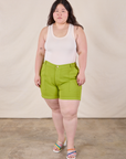 Ashley is 5’7” and wearing 1XL Classic Work Shorts in Gross Green paired with a Tank Top in Vintage Tee Off-White