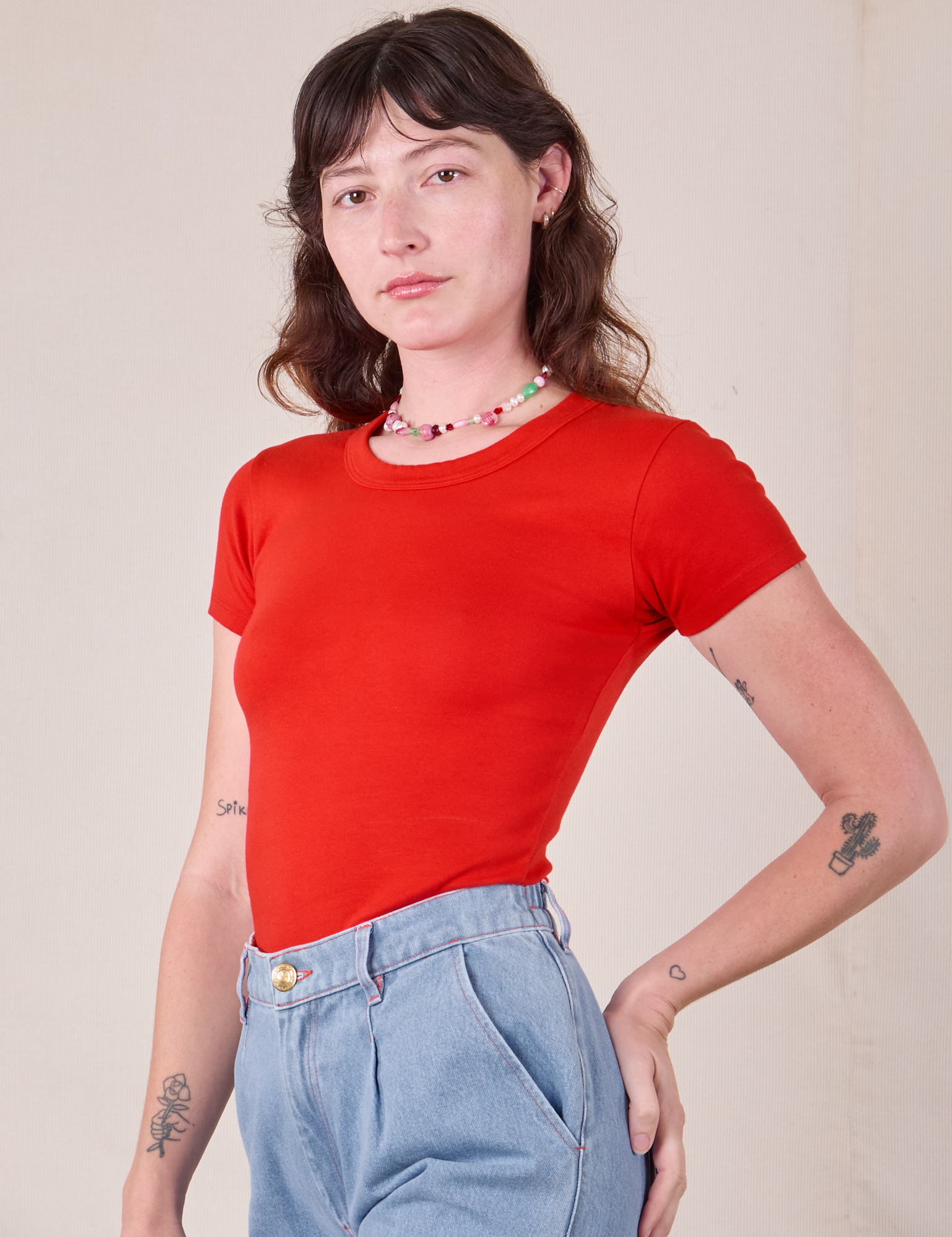 Baby Tee in Mustang Red angled front view on Alex