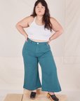 Ashley is 5'7" and wearing 1XL Petite Bell Bottoms in Marine Blue paired with Halter Top in vintage tee off-white