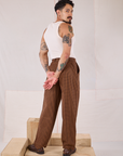 Angled back view of Checker Trousers in Brown & Black and Tank Top in vintage tee off-white on Jesse