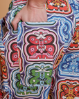 Close up of Alex's hand in the back pocket of Butterfly Kaleidoscope Drop Pocket Cargo Pants