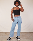 Jerrod is wearing Cropped Cami in Basic Black and light wash Carpenter Jeans