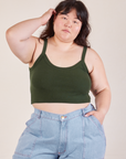 Ashley is 5’7” and wearing L Cropped Cami in Swamp Green paired with light wash Carpenter Jeans