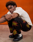 Isaac is wearing Paintstamped Work Pants in Explosion and Organic Vintage Tee in Vintage Tee Off-White