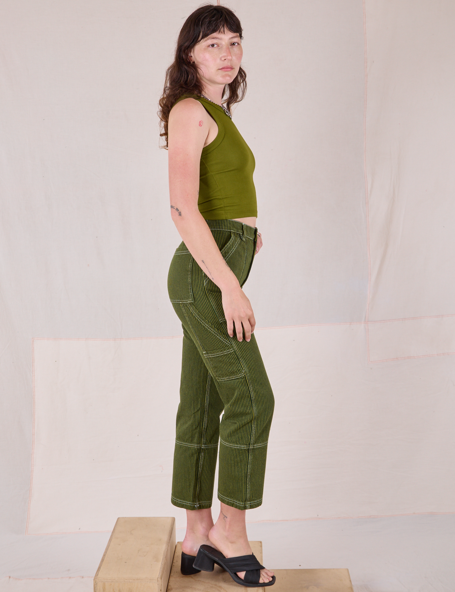 Side view of Railroad Carpenter Jeans in Summer Olive and Muscle Tee on Alex