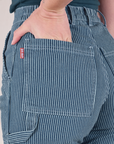Close up of Alex's hand in the back pocket of Railroad Carpenter Jeans in Baby Blue