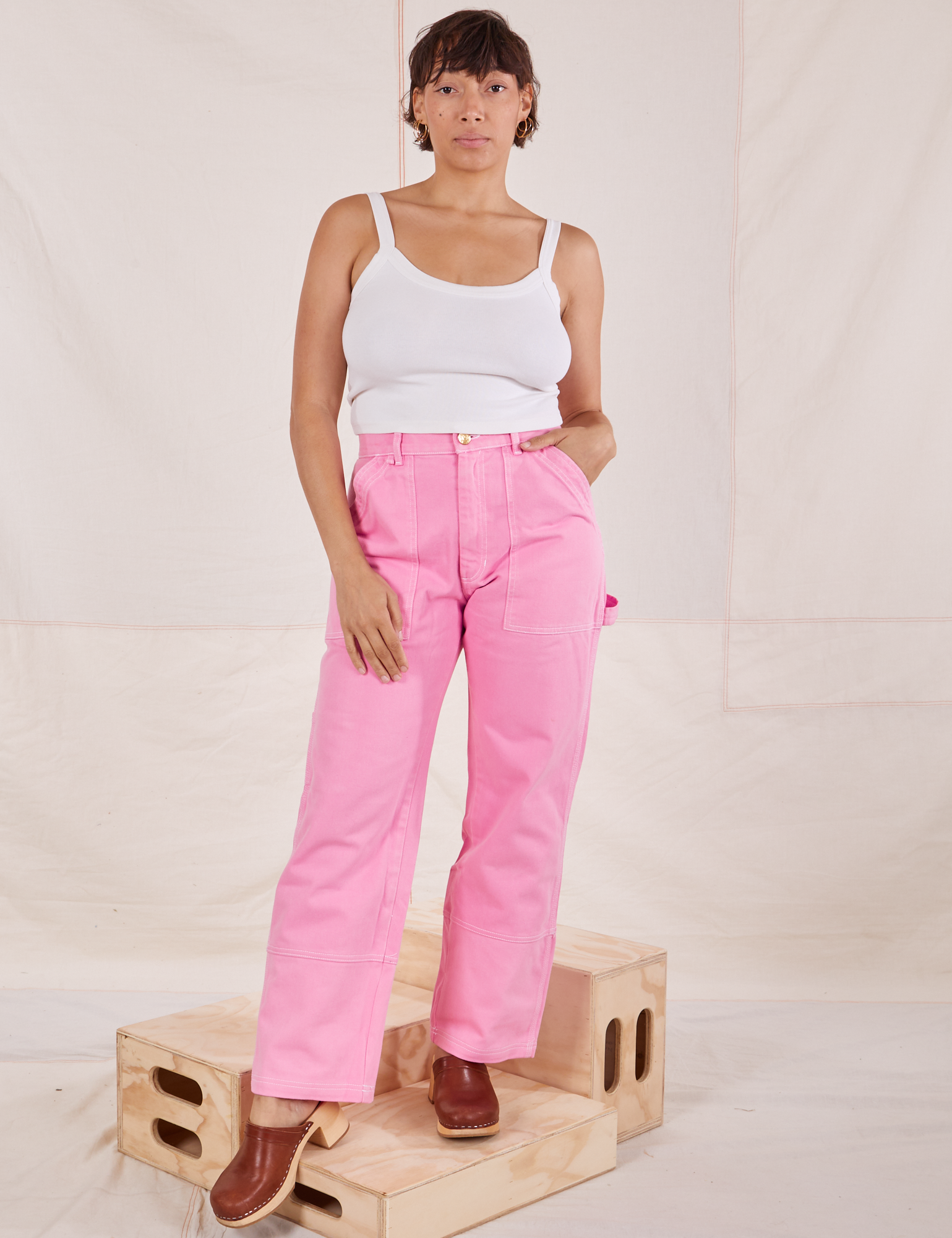 Tiara is 5&#39;4&quot; and wearing S Carpenter Jeans in Bubblegum Pink paired with a vintage off-white Cami
